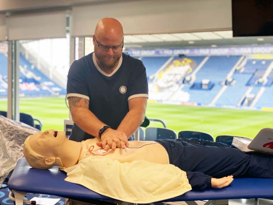 Man performing CPR on dummy